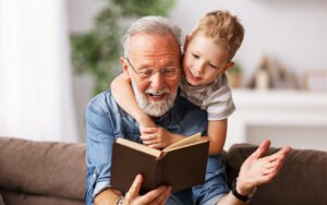 A man is reading a book to a child.